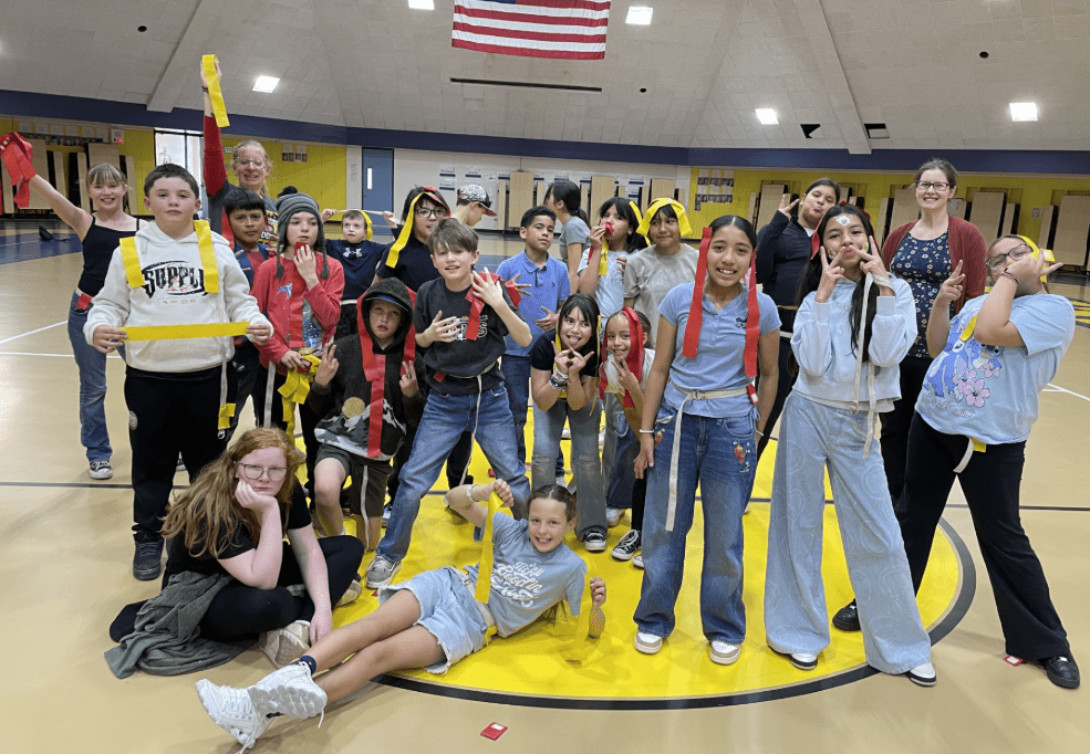 students posing after playing games in the gym