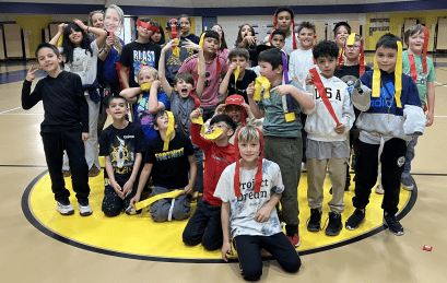 students posing after playing games in the gym